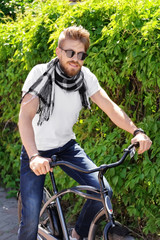 Young man with bicycle in park