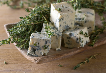 Blue cheese on a wooden table .