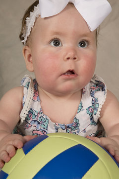 dazed look baby with ball