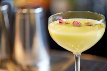 close up of glass with cocktail at bar
