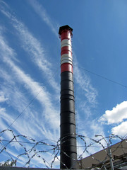 red and white industrial pipe on background blue sky.