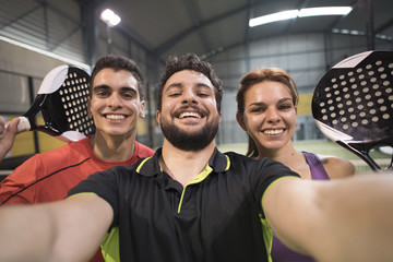 Paddle tennis players taking selfie after macth