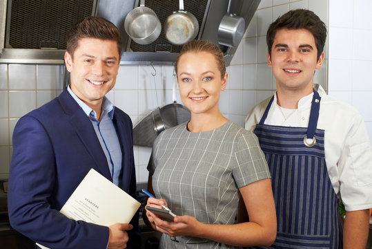 Portrait Of Restaurant Team Standing In Kitchen