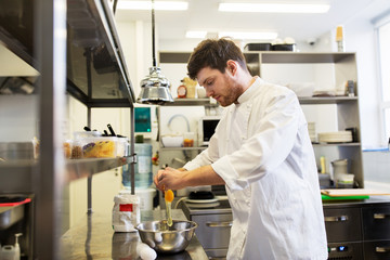 happy male chef cooking food at restaurant kitchen