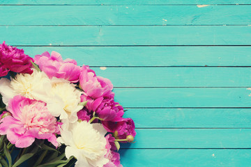 Floral frame / background with beautiful pink, purple and white peonies on old turquoise wooden planks. Shabby chic, vintage flowers for wedding, Happy Mother's day or Women's day