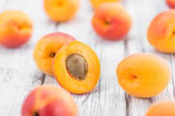 Fototapeta na wymiar Portion of Fresh Apricots on wooden background (selective focus)