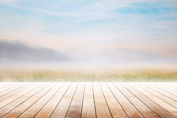 Empty wooden table and mountain with fog and mountain at morning blurred background