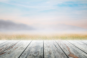 Empty wooden table and mountain with fog and mountain at morning blurred background
