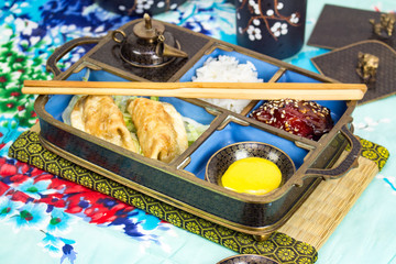 Chopsticks, rice, pork, pot stickers and hot mustard 