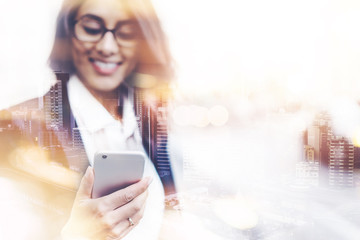 Double exposure concept with professional business woman in black jacket using smartphone while...