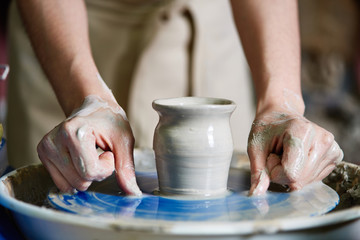 The potter aligns the product on the potter's wheel