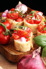 Bruschetta with tomatoes, herbs and oil on toasted garlic cheese