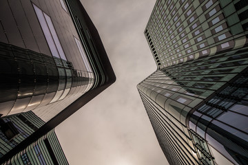 Fototapeta na wymiar Glass silhouettes on modern building
