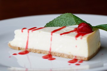 Close-up of the portion strawberry cheesecake on a white plate
