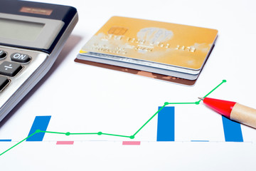 Checking the financial statement sheet with credit cards, calculator and pen