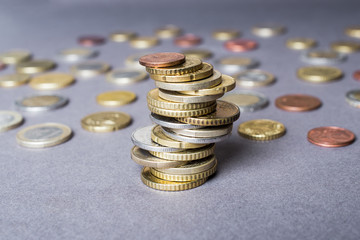 Coins stacked on each other in different positions. Money concept.