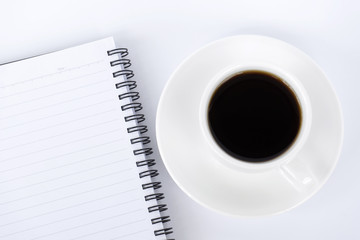 To view of coffee and notepad on white background