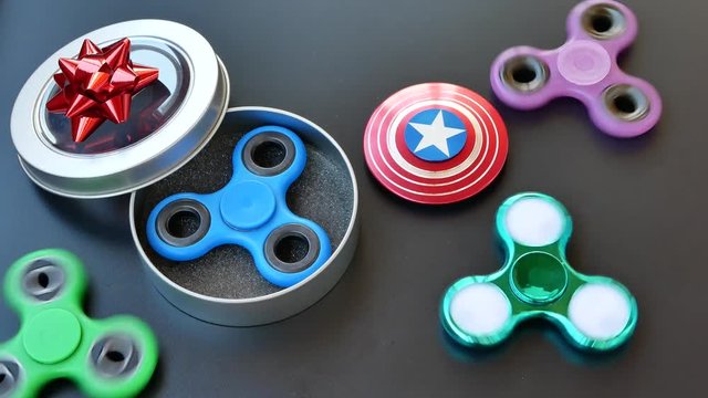 Popular colourful fidget spinner toy in a gift box on a black background