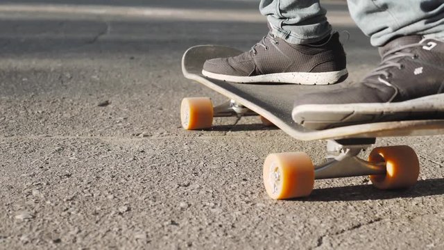 Boy Skateboarding Jump Lifestyle Hipster Concept, flip ollie trick, close up riding on longboard