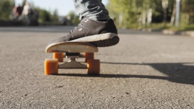 Boy Skateboarding Jump Lifestyle Hipster Concept, flip ollie trick, close up riding on longboard