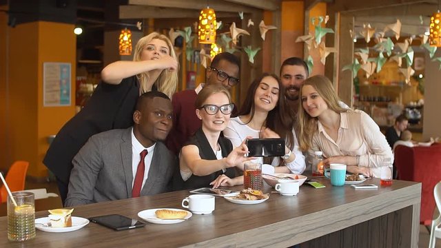 Multinational group of friends in a cafe doing selfi