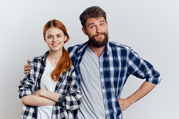 Young guy with beard and beautiful woman on white isolated background, repair, housework