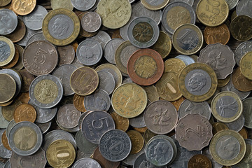A pile of coins from different countries