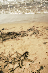 drawings on sandy beach