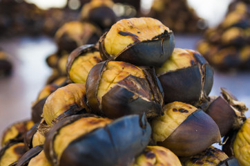 Split roasted chestnuts in metal pan in street cafe