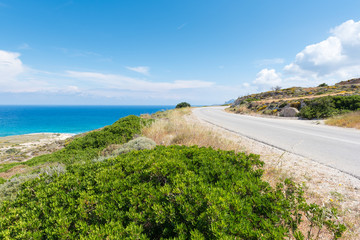 Beautiful coastal road along crystal blue sea water on Milos island. Cyclades, Greece