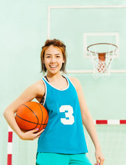 Portrait of happy teenage girl, basketball player
