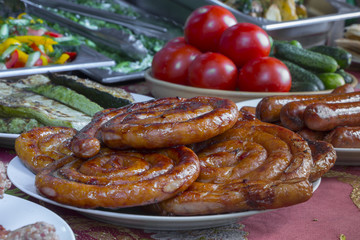Traditional food. Smoked sausages meat hanging in domestic smokehouse
