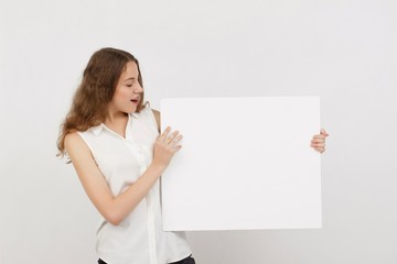 Young woman holding blank poster.Smiling woman sign board holding. Girl showing banner with copy...