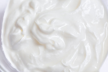 Fototapeta na wymiar White whipped or sour cream on white background, close up, macro