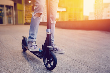 hipster man,  young on a scooter. Processing Sun ray, exposure. Concept of mobile transport in the...