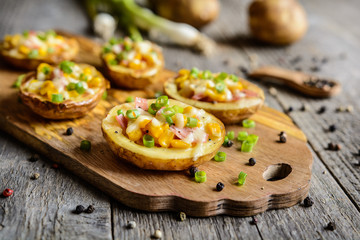 Potato boats filled with corn, ham, cheese and green onion