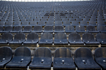 Empty tribune with black seat on soccer sdadion