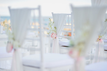 luxury wedding decorations with gentle rose and white tones, number of white wedding chairs, background