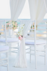 luxury wedding decorations with gentle rose and white tones, number of white wedding chairs, background