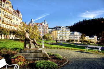 Panorama view of Goethe square with statue, hotel buildings and fountain in the spa park of the town Marianske Lazne (Marienbad) - Czech Republic (region Karlovy Vary)