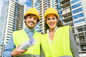 Architects supervising progress of high rise project