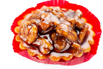 Walnut cake with caramel and honey. Close up on white background