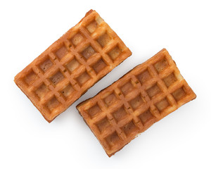 Pair of fresh soft belgian waffles isolated on white background. Top view, close up.