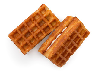 Pair of fresh soft belgian waffles isolated on white background. Top view, close up.