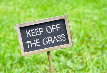 Keep off the grass - chalkboard with text on green grass background