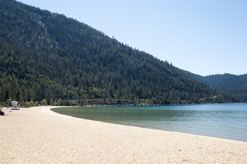 Beach at lake tahoe, california with forest and mountain