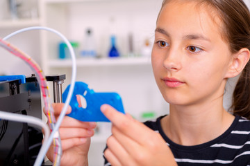 Schoolgirl with 3d printe. education, technology.