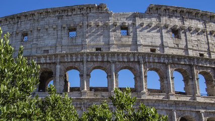 Fototapeta na wymiar Dettaglio della parte alta del colosseo. Anticamente era usato per gli spettacoli di gladiatori e oggi è un simbolo della città di Roma e una delle sue maggiori attrazioni turistiche del mondo