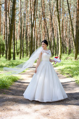 Fashion photo of a beautiful bride with flowers bouquet 