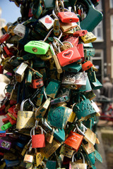 Small locks inscribed with message on pole in Amsterdam, Netherlands